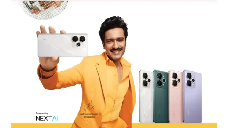 Realme 15 Pro Launching in India With 7,000mAh Battery, 6,500 Nits Display and IP69 Rating 4 Vicky Kaushal holding a white Realme 15 Pro 5G phone, with other color variants (green, pink, purple) displayed beside him.